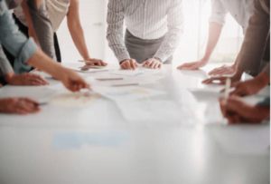 a group of colleagues are discussing of subject around the table